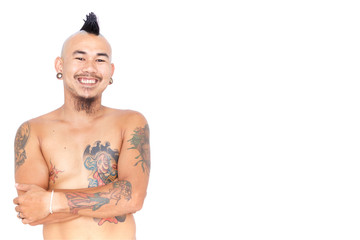 portrait of friendly asian punk guy with mohawk hair style, piercing and tattoo isolated on a white background