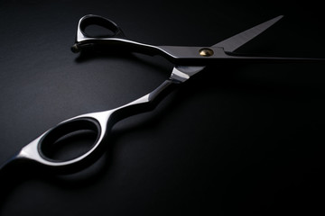 professional scissors on black background - obrazy, fototapety, plakaty