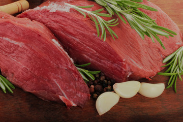 fresh raw beef steaks isolated onwooden background