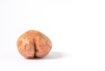 Raw funny potato in a shape of ass.