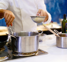 Fototapeta na wymiar Chef cooking spaghetti in the kitchen