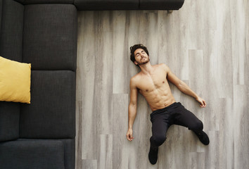 Muscular Handsome Young Man Sleeping After Working Out at Home