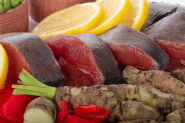  humpback salmon slices with spices on wooden background