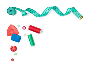 Set from sewing Accessories (a centimetric measuring tape, a set of buttons, swept  for fabric, color threads) on the white isolated background. The place for a text inscription