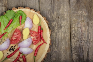 chili pepper on wooden stub on wooden background