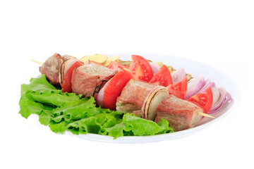 shashlik with lettuce, tomatoes and onion isolated on white background