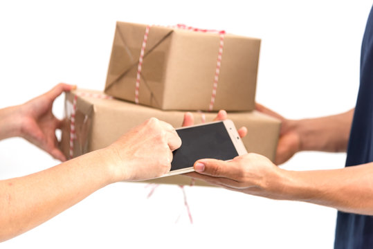 Carrier man delivered products boxes to customer to Home , Messenger delivery man gives cellphone application for signs and takes boxes. Isolate on white background.Technology for e-business for sale