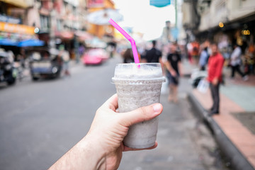Fresh dragon fruit smoothie. Background is street.