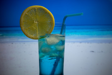 Blue Lagoon cocktail in highball glass with a straw