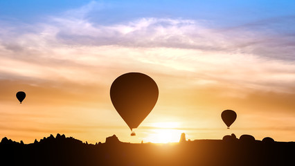 Hot air balloon silhouettes in mountains at sunrise, Goreme, Cappadocia, Turkey