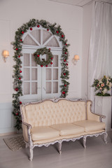 Christmas decoration at home. Beige sofa in the interior of the house
