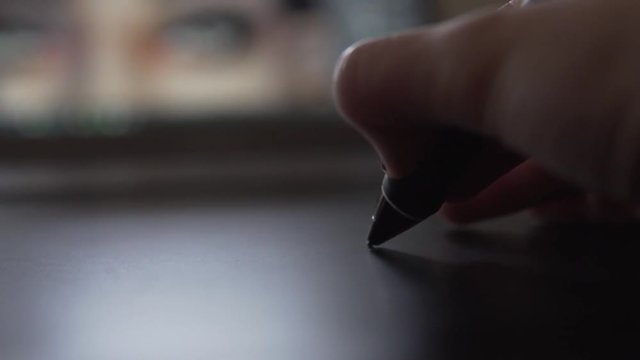 SLOW MOTION: Close Up of a digital pen on graphic tablet with painting