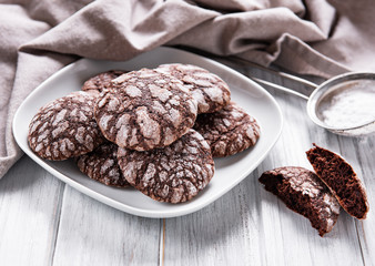 Crackled chocolate cookies on a old wooden table