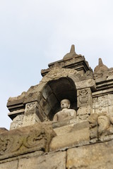 Naklejka premium Borobudur Temple with the Buddha statue during sunrise, Yogyakarta, Indonesia