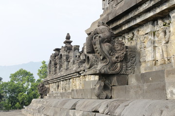 Fototapeta na wymiar Beautiful bas-relief as wall decor carved in stone at Borobudur Temple, Yogyakarta, Indonesia