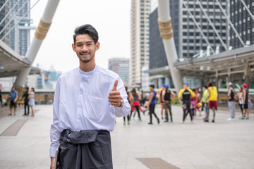 Myanmar businessman are smiling with thumbs up poses on people group background