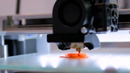 Print head of 3D printer machine printing plastic model at modern scifi technology exhibition. 3D printing, additive technologies, 4.0 industrial revolution and futuristic concept