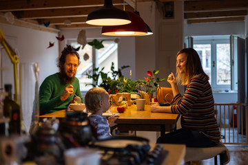 Family having breakfast together during the morning at the kitchen.