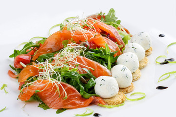 The salad with salmon and cottage cheese balls on a white background