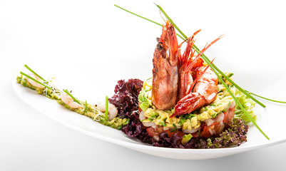 Salad with Royal shrimps and avocado on white background