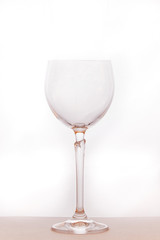 wine glass glitters in the sun  close-up on a white background