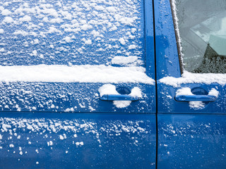 closeup of snow covered side door of car