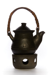 Black Chinese teapot with heater close up on a white background