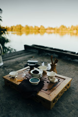 Tiny tea ceremony outdoor on the lake bank in daylight