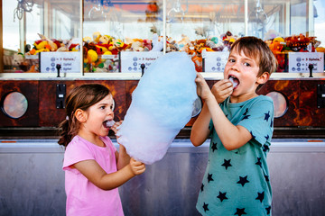 Children eating cotton candy at the carnival