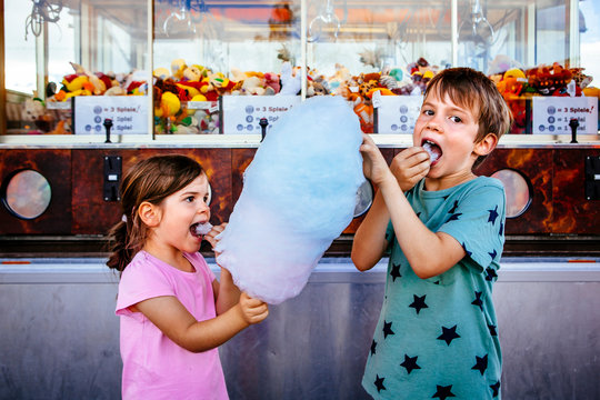 Children eating cotton candy at the carnival