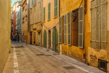 Fototapeta na wymiar Old Narrow street and apartment buildings in Toulon, Riviera, Cote d'Azur, France