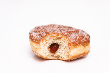 Traditional German or Austrian fried donuts with no hole, so called Krapfen, Berliner or Pfannkuchen with cinnamon sugar and filled with rose hip, raspberry or strawberry jam, party or carnival food
