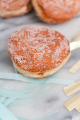 Fototapeta na wymiar Traditional German or Austrian fried donuts with no hole, so called Krapfen, Berliner or Pfannkuchen with cinnamon sugar and filled with rose hip, raspberry or strawberry jam, party or carnival food