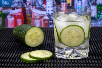 Gin and Tonic Cocktail in old fashioned glass with cucumber and ice