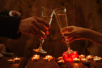Man and woman with glasses of wine. Romantic dinner by candlelight.