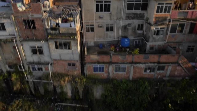 Favela Aerials: Rising past houses at sunrise on mountain, Rio de Janeiro, Brazil