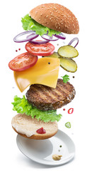 Hamburger ingredients falling down one by one to create a perfect meal. Colorful conceptual picture...