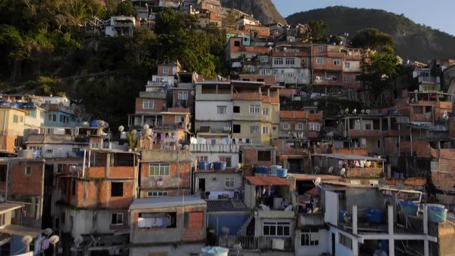 Favela Aerials: Rising past houses at sunrise on mountain, Rio de Janeiro, Brazil