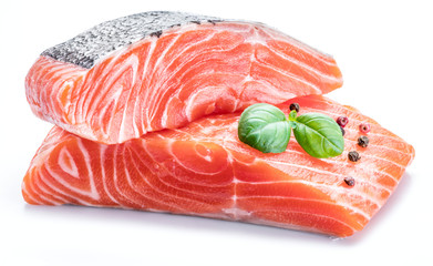 Fresh raw salmon fillets  decorated with green basil.