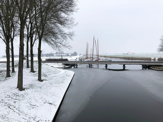 Skutsjes during winter in Sloten, Friesland