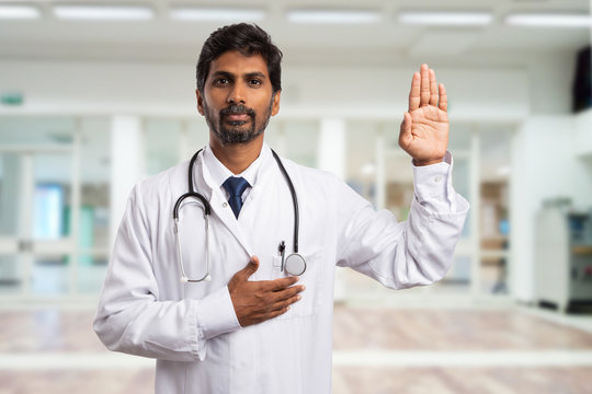 Medic swearing with hand on heart.