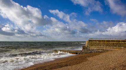 Landscape view of beach with marbles and stone pear. Brighton, United Kingdom.