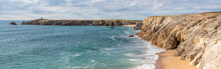 Fototapeta na wymiar French landscape - Bretagne. A beautiful beach with wild cliffs in the background. Panoramic view.