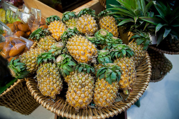 Pineapples are in the wattle basket at the grocery store