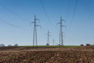 cultivated field and poles of electric current