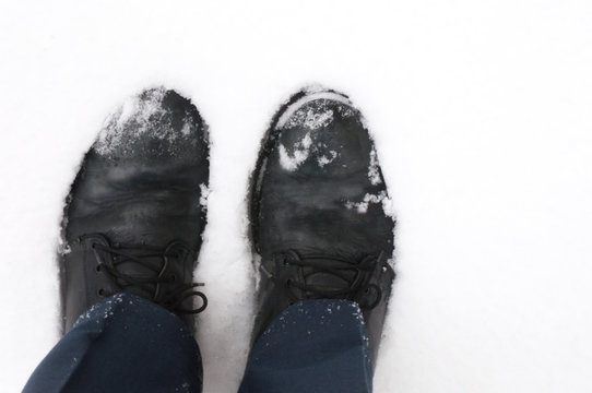 black men's boots in the snow