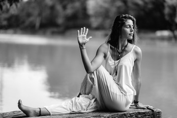 Yoga Woman by The Lake. Seated Spinal Twist