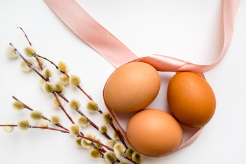 Eggs with willow on a white background (easter concept)
