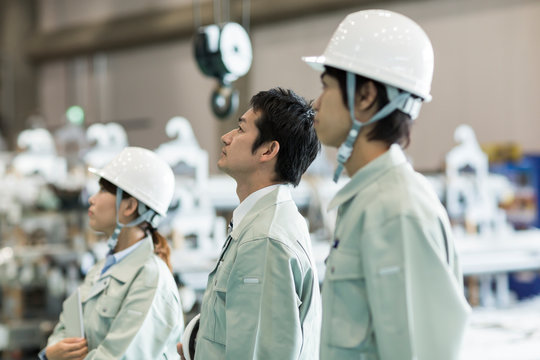 Male and female worker standing in factory