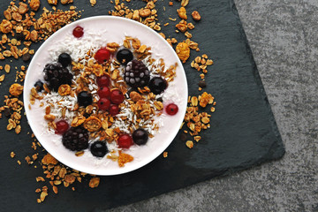 Healthy breakfast bowl with yogurt, granola and berries. Keto diet. Concept proper breakfast. Flat Lay.